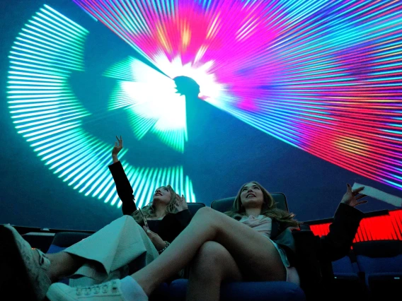 two young women in flandrau planetarium at a laser show