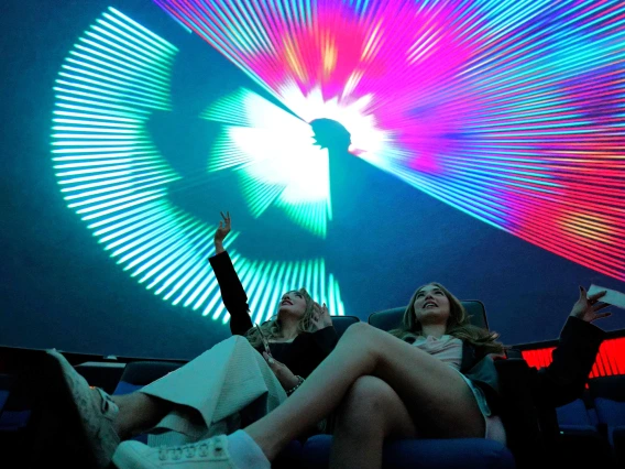 two young women in flandrau planetarium at a laser show