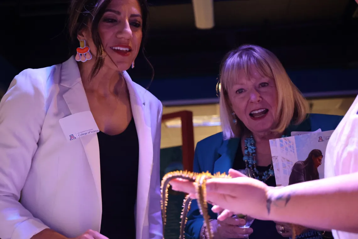 Two woman learn about marine life at Flandrau's Undersea Discovery exhibit in Tucson