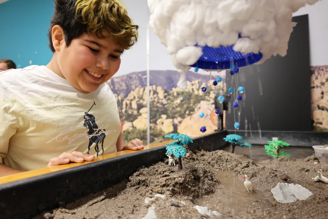 Child participates in precipitation demonstration