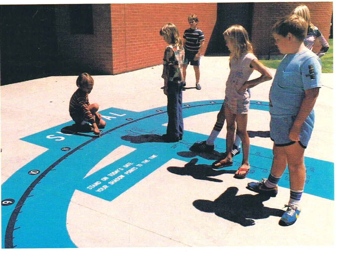 Children explore a sidewalk sundial in front of Flandrau in 1982